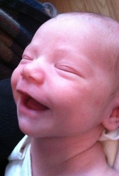 newborn infant laughing